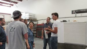 Metallurgical and Materials Engineering students ask questions about the front load furnace on the manufacturing floor
